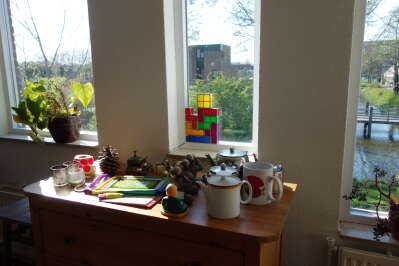Tetris lamp, sitting in the frame of the tall, narrow window